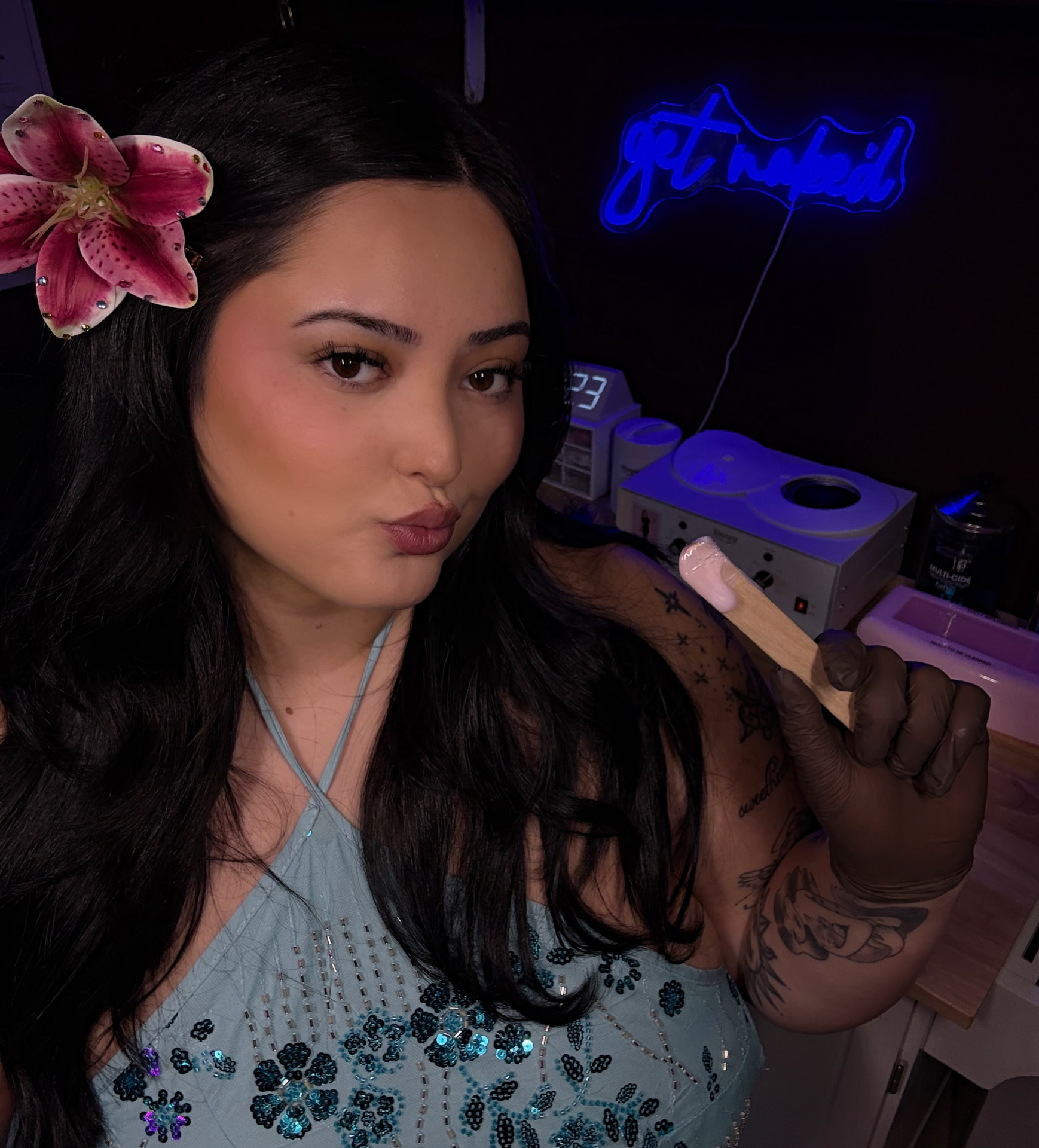 Taylor holding a wax applicator in the Bare Hibiscus studio